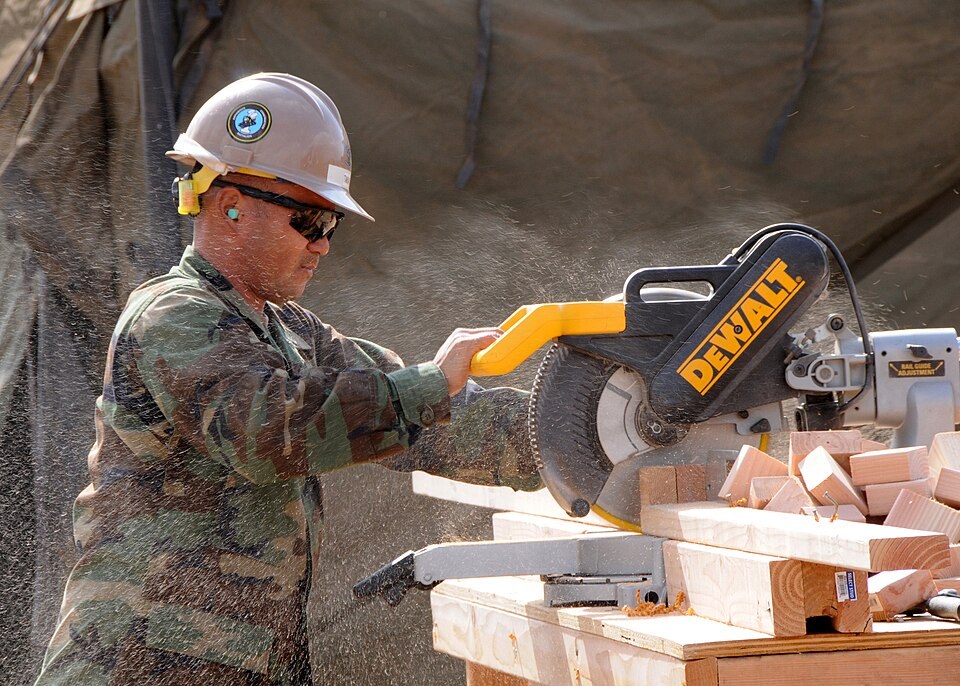 Cutting a board with a sliding miter saw