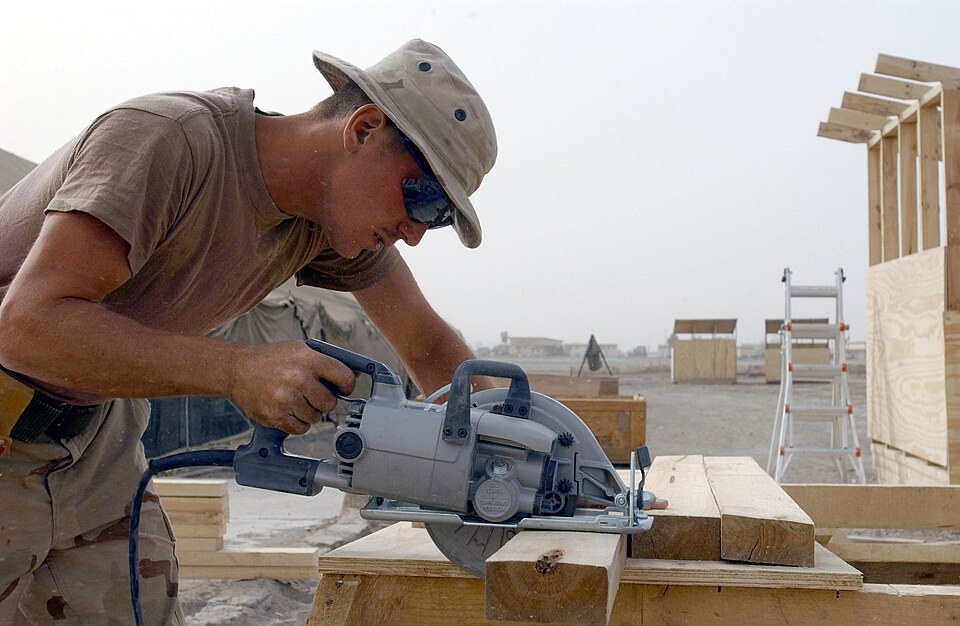 Builder cutting lumber with a circular saw