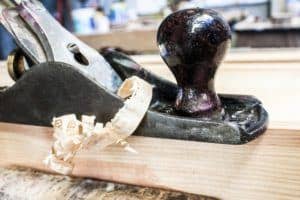 wood plane and pine wood planks , construction background