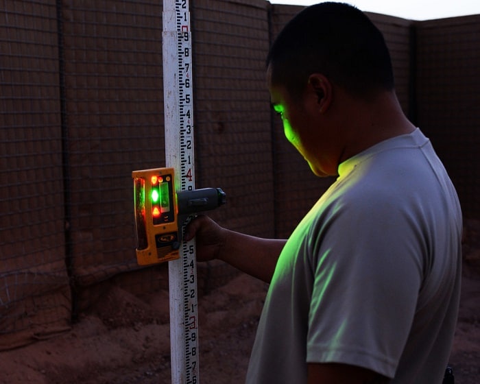 craftsman observes a reading from a laser level