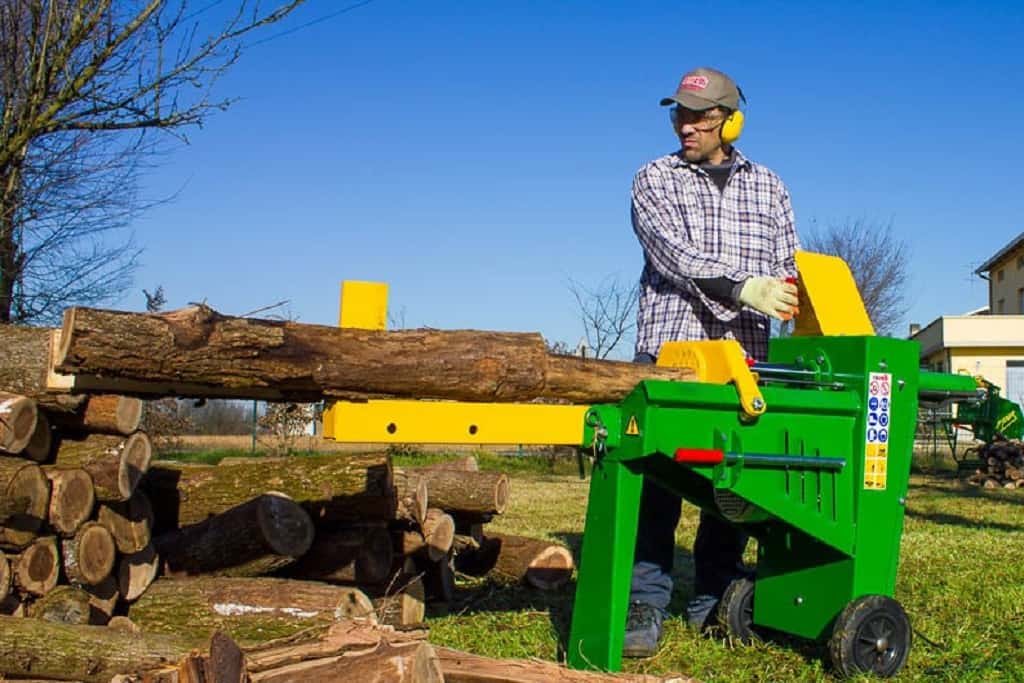 man operating a log splitter machine