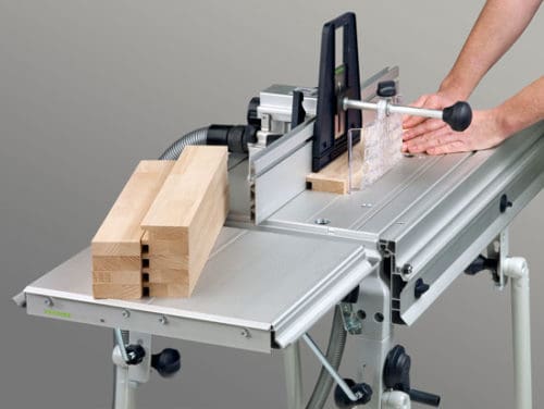 Man cutting a wood on the table