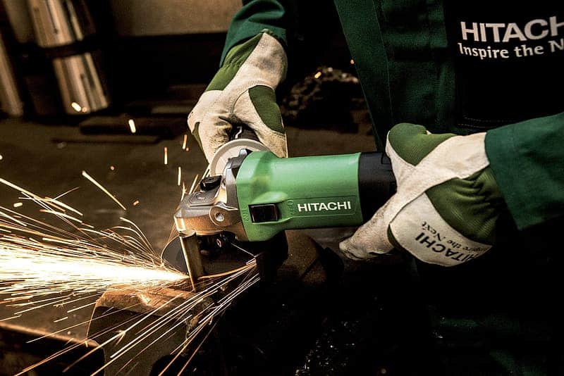 Person using green Hitachi angle grinder